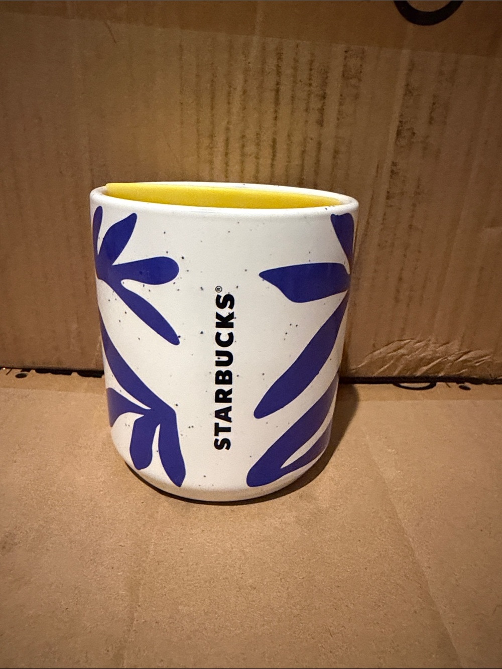 Starbucks White Ceramic Tumbler with Blue Leaf Motif and Yellow Interior